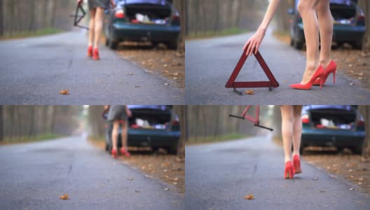 穿着红色高跟鞋的苗条女人的腿和汽车故障标志。慢动作高清在线视频素材下载