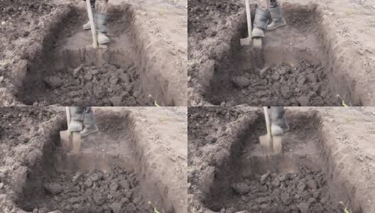 人挖了一个深坑。用铁锹挖坑。高清在线视频素材下载
