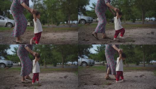 奶奶拉着小女孩的手学走路。高清在线视频素材下载