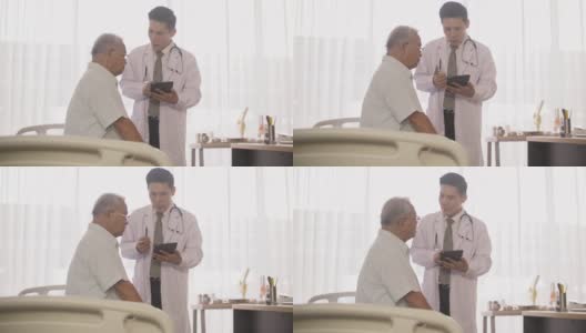 医生在报告老年病人的问题时使用平板电脑高清在线视频素材下载