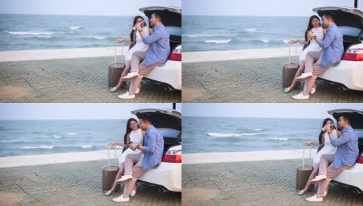 浪漫的亚洲情侣在海滩上开车野餐，生活理念。高清在线视频素材下载