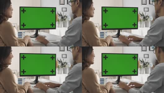 两个人用电脑，对着绿屏说话，色度键高清在线视频素材下载