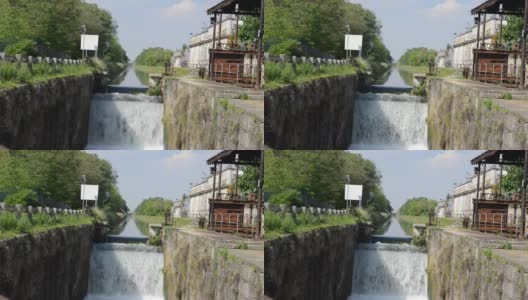 连接米兰市和意大利帕维亚的Naviglio Pavese运河的水闸上瀑布的实时画面高清在线视频素材下载