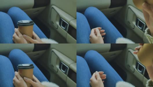 女孩拿着一杯咖啡坐在车里高清在线视频素材下载