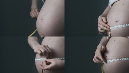 孕妇撩起衬衫量肚子高清在线视频素材下载