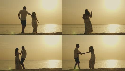 一对年轻夫妇的剪影，在大海和夕阳的背景下滑稽地跳舞。海边的快乐假期高清在线视频素材下载