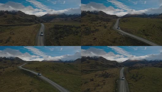 鸟瞰图SUV驾驶在沙漠向雪山山峰在新西兰高清在线视频素材下载