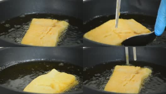 厨师在平底锅里煮一种填满果酱、蘸牛奶和鸡蛋的吐司面包高清在线视频素材下载