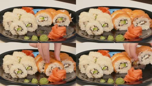 小心地把寿司卷放在盘子里高清在线视频素材下载