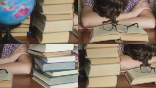 一个年轻的学生正在一张木桌上睡觉，书打开着高清在线视频素材下载