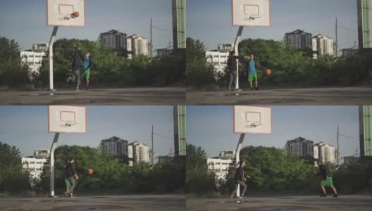 早上，一名亚裔中国老人和他的女儿在篮球场练习篮球高清在线视频素材下载