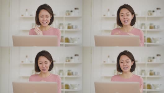 亚洲商务女性使用笔记本电脑进行视频通话，通过网络摄像头进行在线聊天，民族女性在家中进行远程聊天工作，新冠肺炎疫情隔离期间进行在线会议高清在线视频素材下载