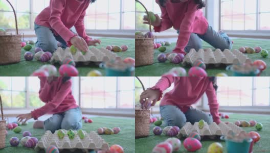 亚洲小女孩把绿色的复活节彩蛋放进嵌板，在家享受复活节庆祝活动高清在线视频素材下载