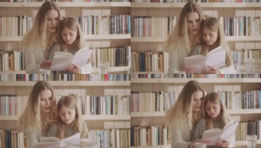 慈爱的母亲和她的小女儿一起读书高清在线视频素材下载