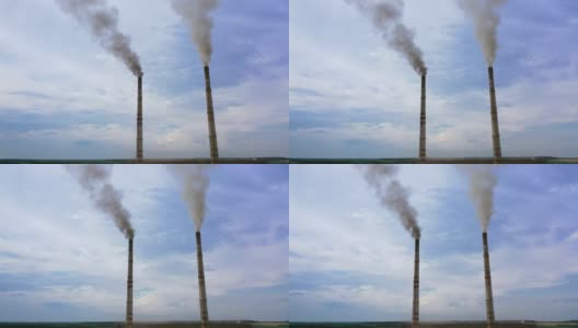 企业的烟囱管映衬着天空的背景释放出黑烟。蓝天下的危险烟雾。工厂污染环境。高清在线视频素材下载