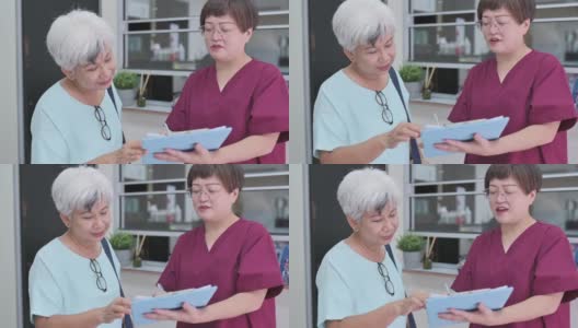 亚裔华裔女护士在诊所向她的资深女病人解释体检报告高清在线视频素材下载
