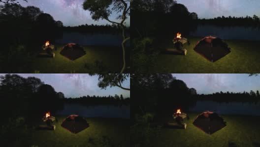 人和狗在湖边的篝火营地享受大自然的宁静夜晚高清在线视频素材下载