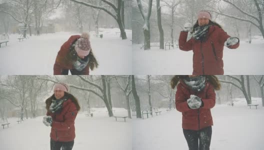 年轻女子在户外享受冬日。雪的冬天的梦想。慢动作高清在线视频素材下载