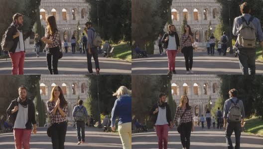 年轻幸福的夫妇走在公园路和有吸引力的年轻人瞥视女友gelousy与树木斗牛场在背景在罗马在日落可爱美丽的女孩与长发牵手慢动作高清在线视频素材下载