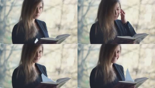 年轻，美丽的女孩读一本书-股票视频高清在线视频素材下载