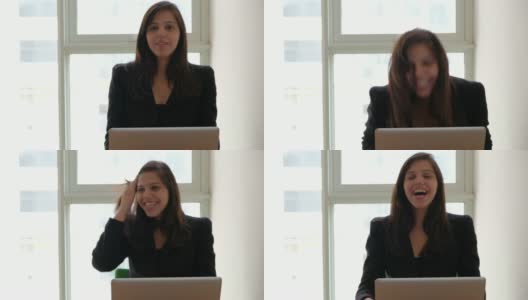 一位同事分享了一个笑话，一位在笔记本电脑上工作的漂亮女性大笑起来高清在线视频素材下载
