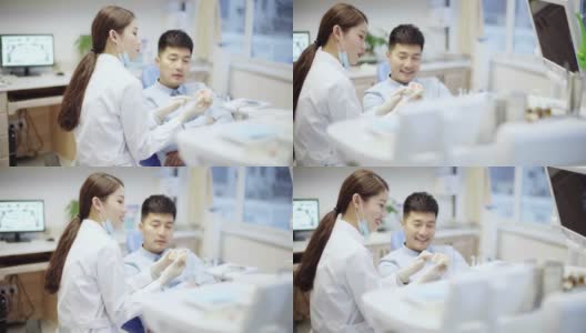 正牙医生在诊所向病人解释植入物高清在线视频素材下载