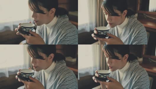 年轻的亚洲女人喝热茶仪式高清在线视频素材下载