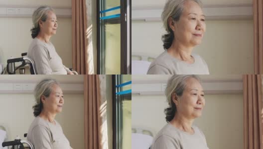 坐在窗边轮椅上的亚裔老太太高清在线视频素材下载