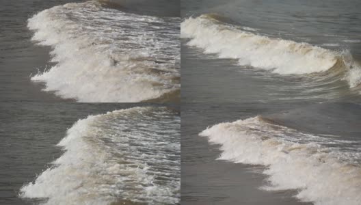 海浪冲上泥泞的海滩，高速摄像机，超慢速动作，180帧/秒，b滚动拍摄。高清在线视频素材下载