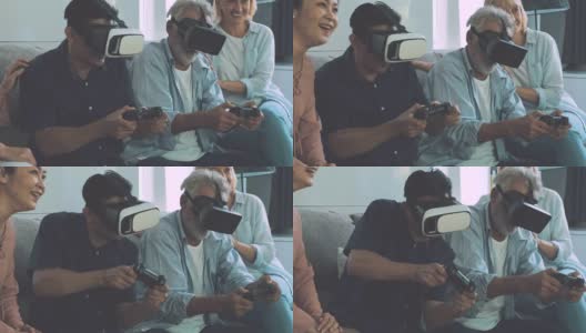 一群老年人在客厅玩VR游戏，专注于玩。白人，亚洲人，泰国人坐在家里的沙发上。退休生活方式的概念。高清在线视频素材下载