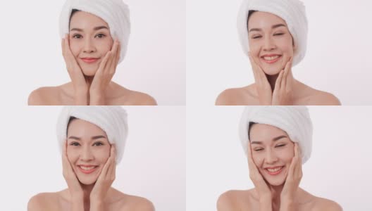 亚洲美丽的女人在白色的背景上使用面霜。高清在线视频素材下载