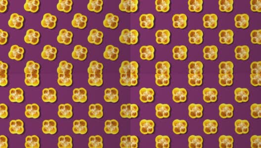黄甜椒切片纺丝图案，粉红色背景高清在线视频素材下载