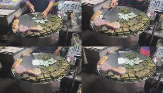 传统的韭菜饺子和蒸饺在亚洲夜市。泰国曼谷的街头小吃。高清在线视频素材下载