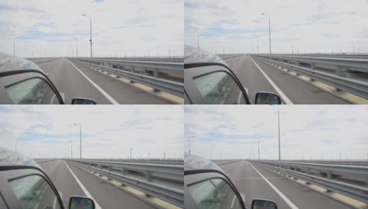 一辆载着游客的汽车沿着新建的克里米亚大桥行驶，这座大桥穿过刻赤海峡，连接着托曼和克里米亚半岛高清在线视频素材下载