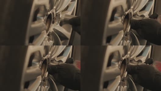 汽车修理工在车库车间更换汽车轮胎。缓慢的运动。汽车服务高清在线视频素材下载