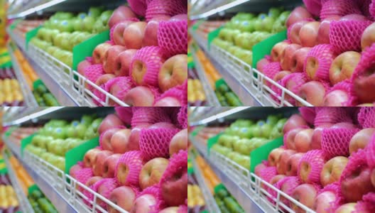 近距离观看超市货架上五颜六色的苹果品种，维生素水果杂货店购物。出口不同品种的苹果至各商店及超级市场高清在线视频素材下载