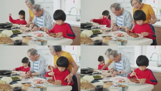 孩子们在春节帮祖父母做饭高清在线视频素材下载