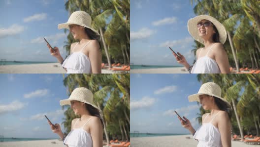 在海滩上玩智能手机的女人，度假高清在线视频素材下载