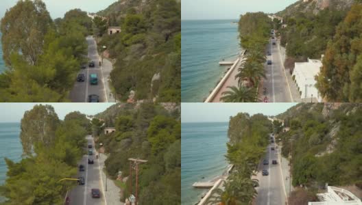 空中-劳特拉基-希腊，向后飞行，显示海岸道路与棕榈树和瀑布高清在线视频素材下载