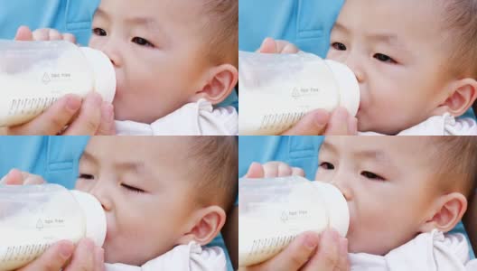 小男孩喝着奶瓶里的牛奶高清在线视频素材下载