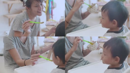 亚洲男婴(6-11个月)在家吃婴儿食品高清在线视频素材下载
