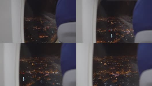 从飞机窗口看到的夜空中的城市夜景高清在线视频素材下载
