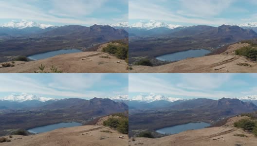 航拍:无人机飞越森林山谷湖，鸟瞰图上的阿尔卑斯雪山，晴朗的蓝天，都灵，意大利。高清在线视频素材下载