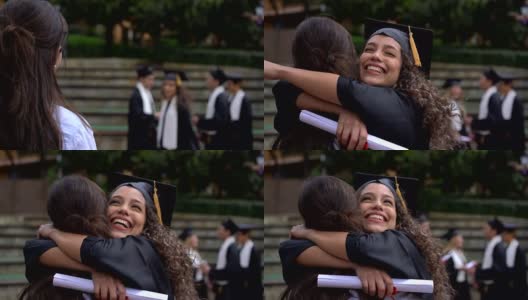 在大学获得学位后，快乐骄傲的学生跑去拥抱她的妈妈高清在线视频素材下载