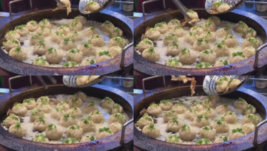 传统的中国小笼包汤圆蒸篮配新鲜热腾腾。有噪声和模糊背景。高清在线视频素材下载