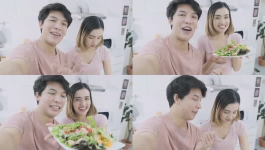 美食视频博客:亚洲夫妇使用POV手机制作视频博客，并在社交媒体上直播，同时烹饪健康果汁饮料和沙拉。在家厨房准备沙拉需要4小时高清在线视频素材下载