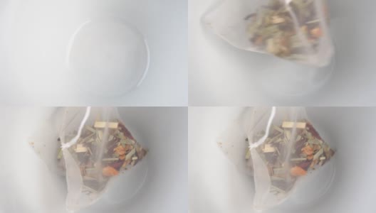 将微型塑料袋中的花草水果茶放入空的白色茶杯中高清在线视频素材下载