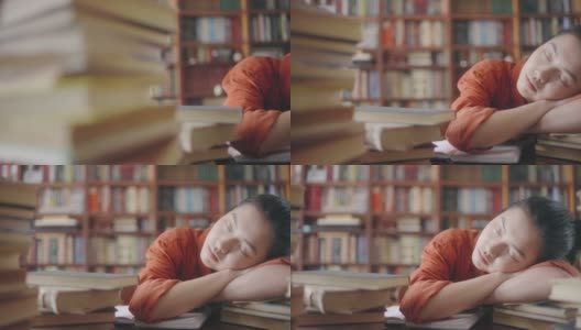 劳累过度的亚洲女学生在图书馆睡觉，厌倦了太多的学习高清在线视频素材下载