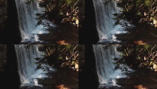 美丽的小瀑布在山林中。胶片颗粒高清在线视频素材下载