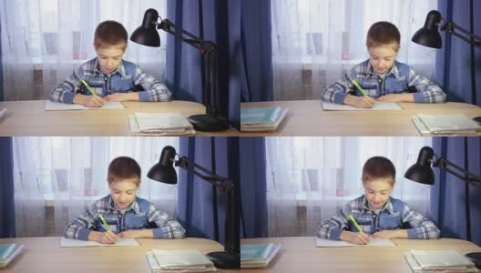 孩子做作业，晚上在桌子上写笔记本高清在线视频素材下载